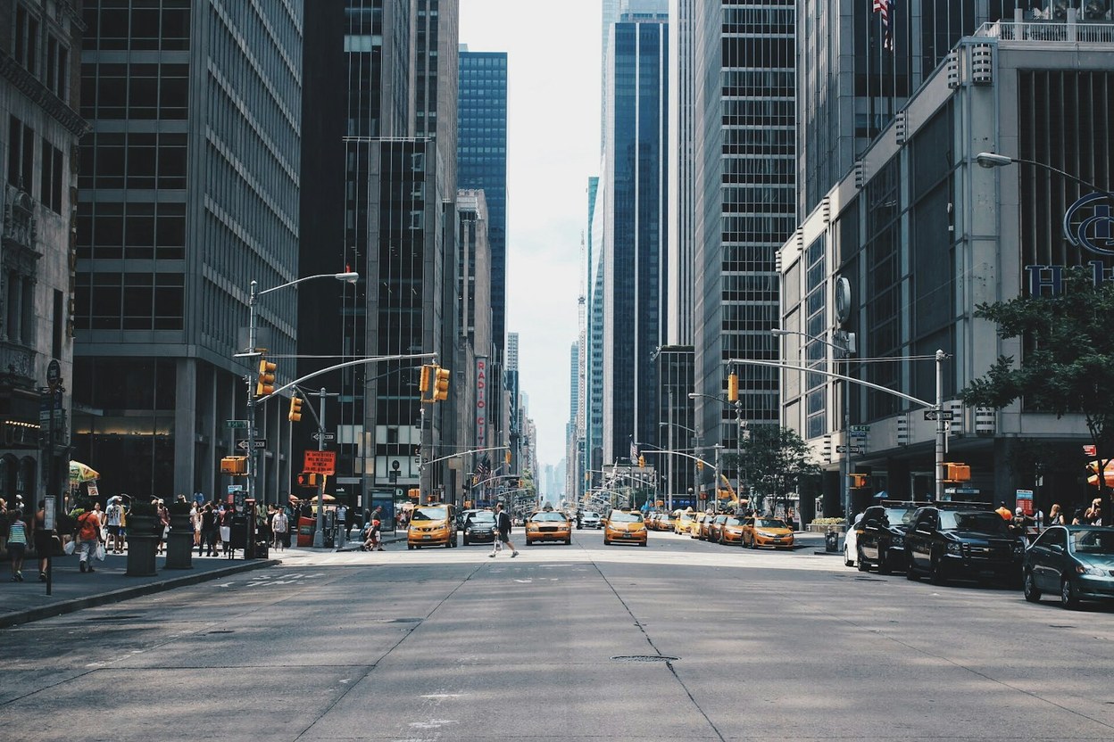 A car parked on a city street at dusk — first license, permit, and what to bring.