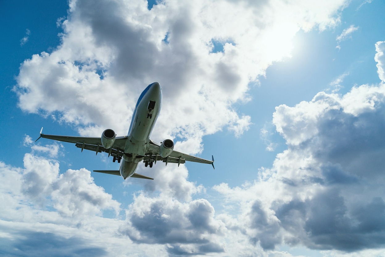 Airplane wing above the clouds — TSA accepts IDs that fly.