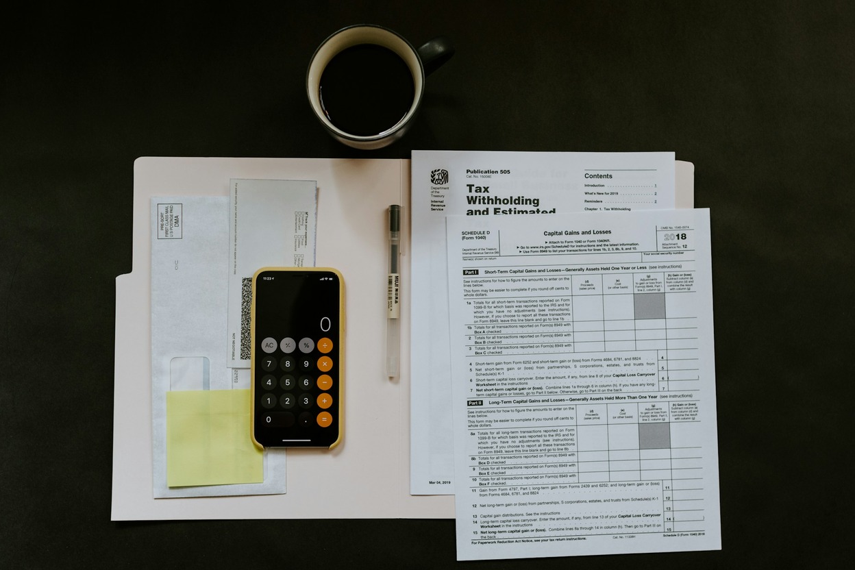Pen and paperwork on a desk — title transfer when buying, selling, or gifting.