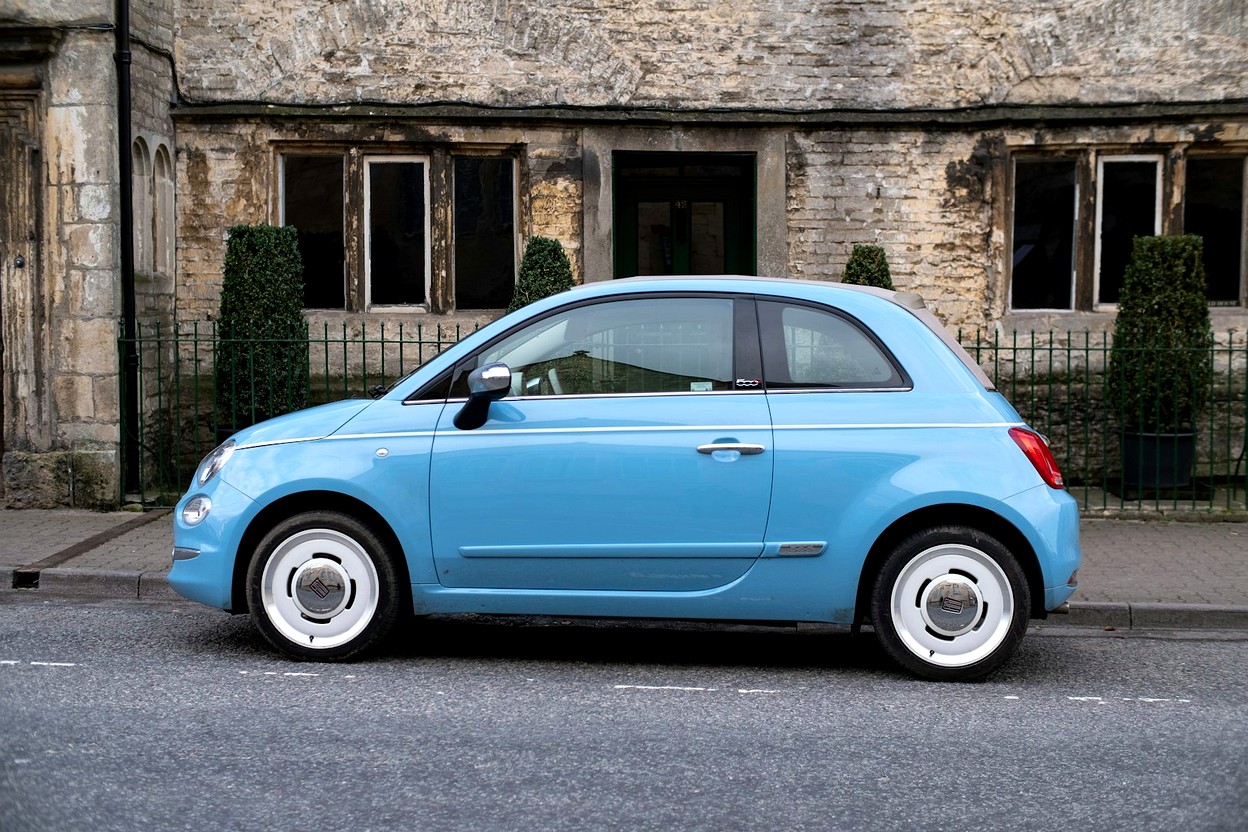 A light blue compact car parked on a quiet street — ready to sell or gift.